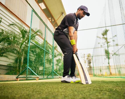 focus on man holding a cricket bat