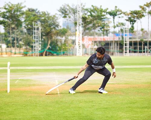 man playing cricket