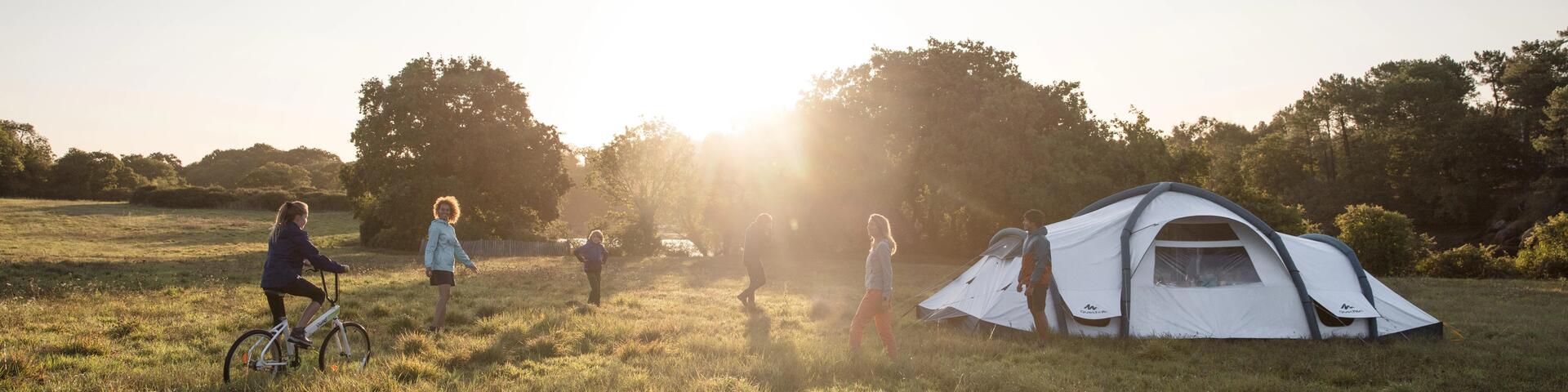 People walking around their tent