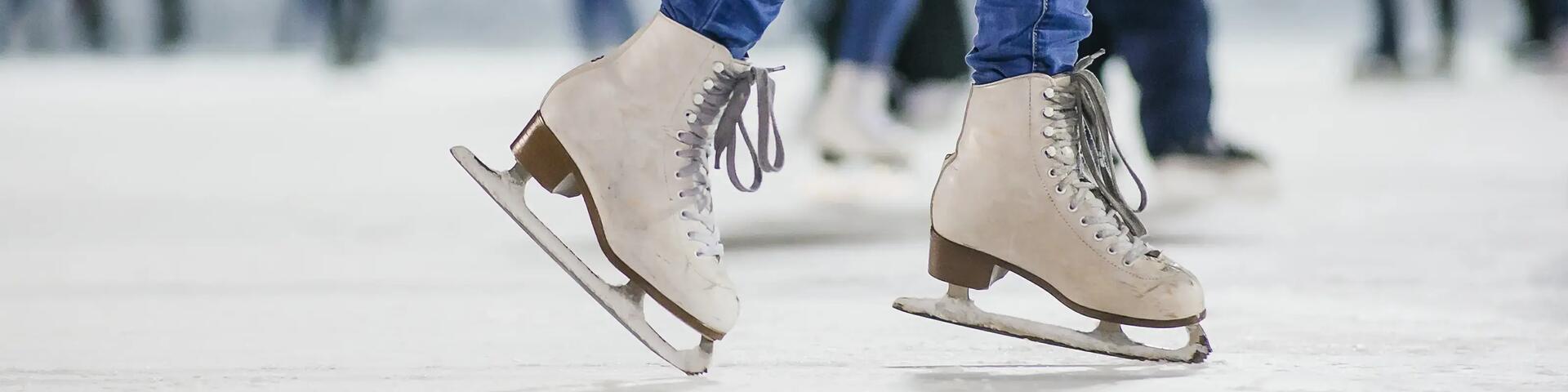 White Ice skates close up on ice rink. 