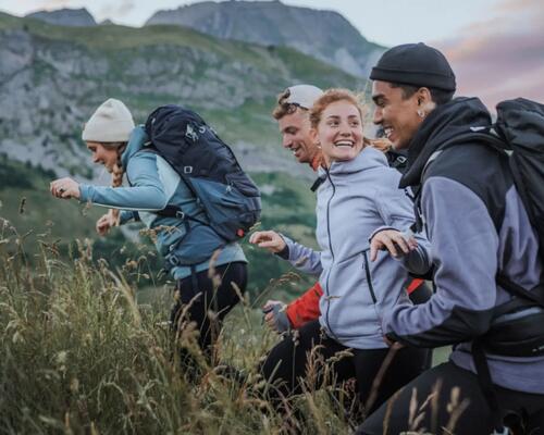 Four young adults out hiking with their backpacks.