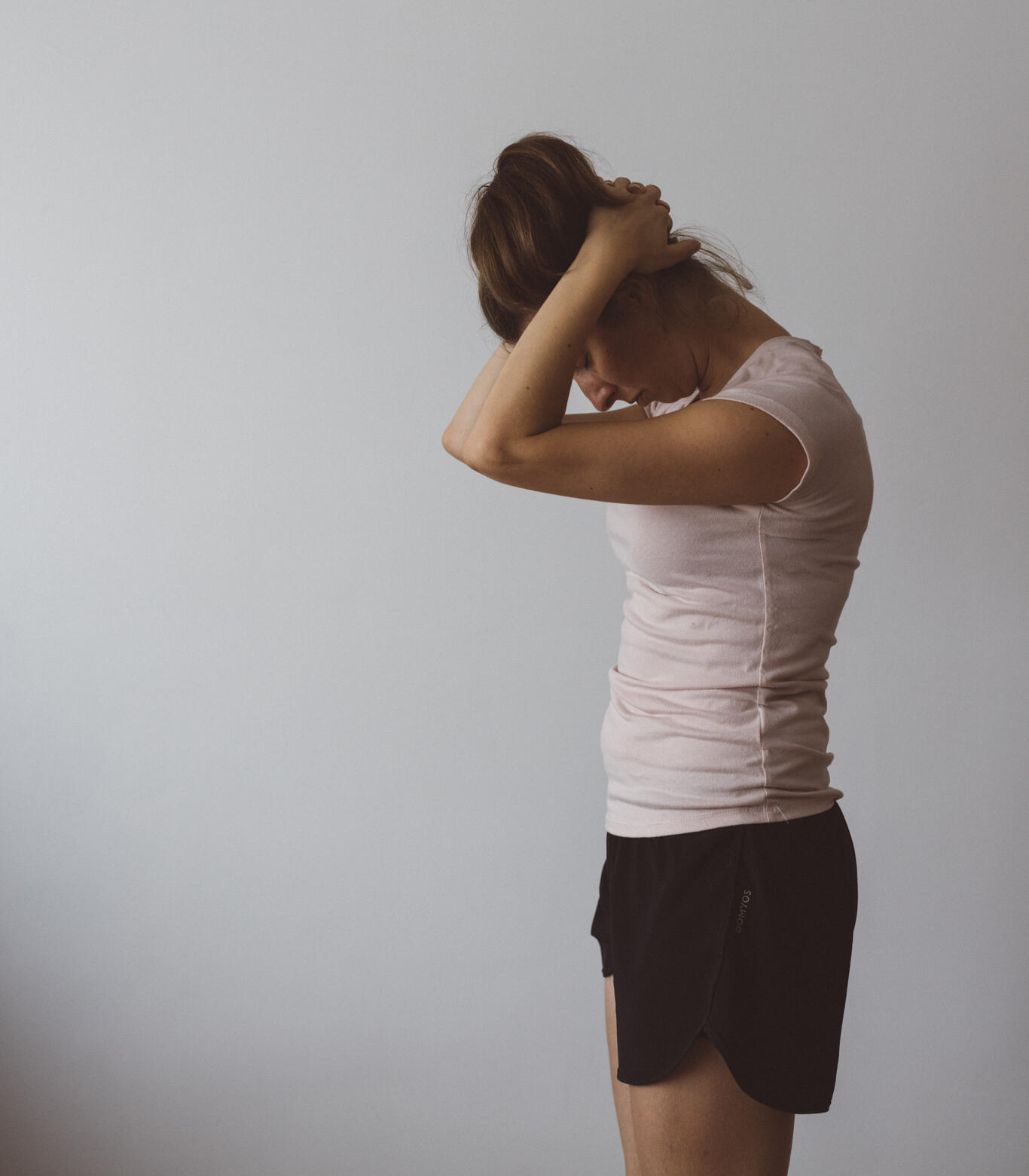 Standing neck stretching exercise