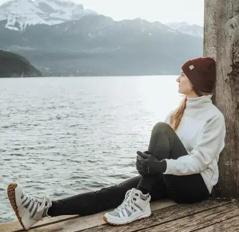 A lady looking out to a lake.