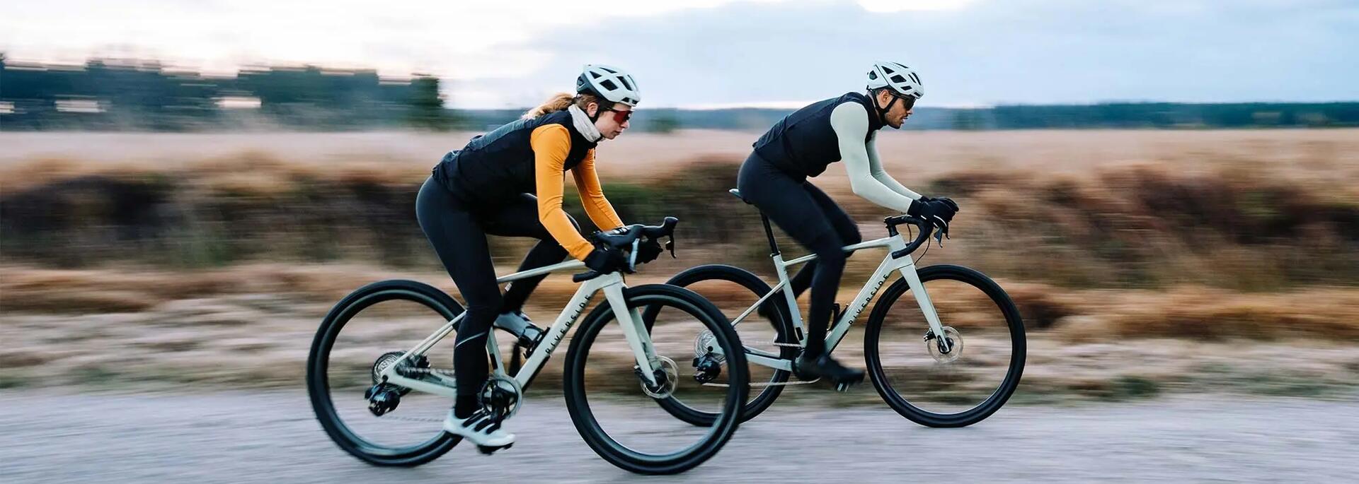 Man and woman cycling fast.