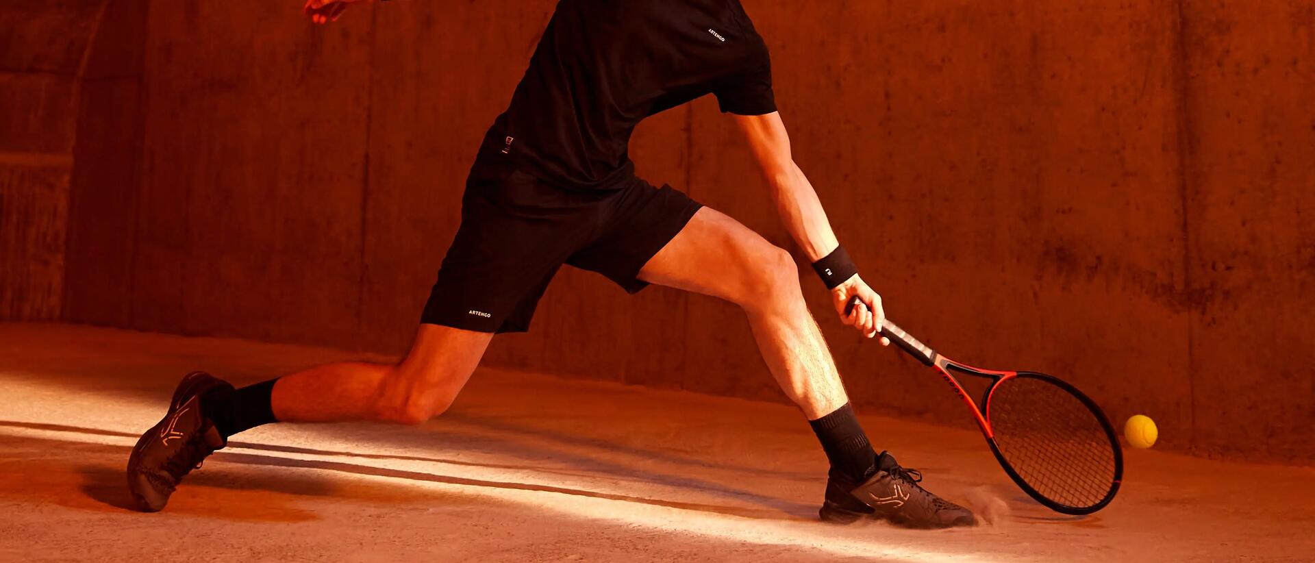 Man playing tennis indoors