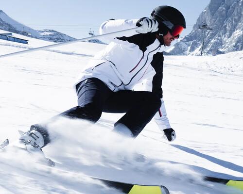 Man skiing in alpes, with close-up on jacket