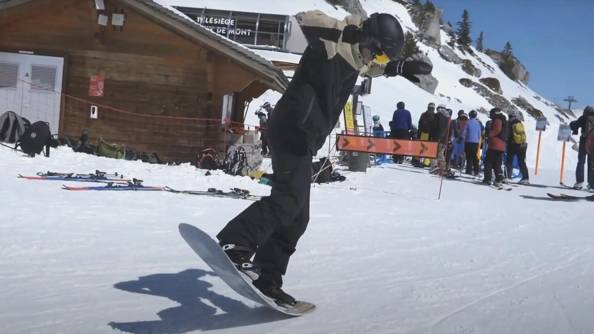 hombre haciendo un nollie en snowboard