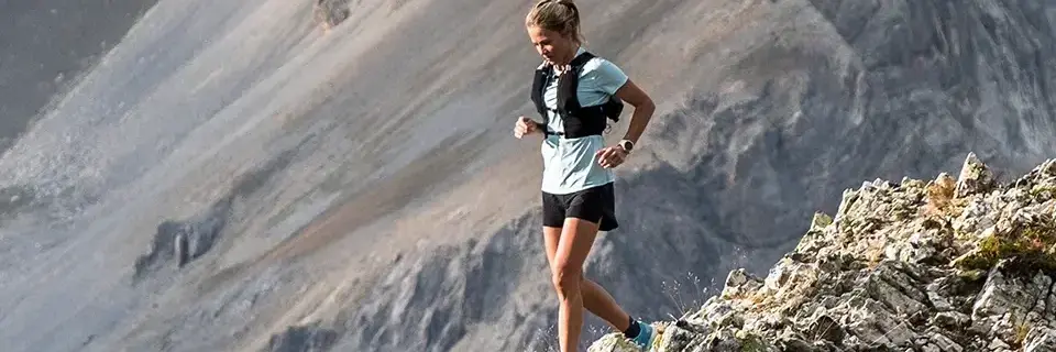 Kobieta w stroju sportowym biegająca po górach odbywająca trening w warunkach hipoksji