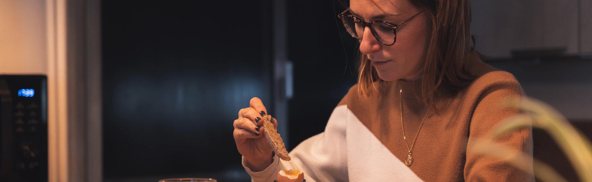 une femme qui mange son oeuf à la coque