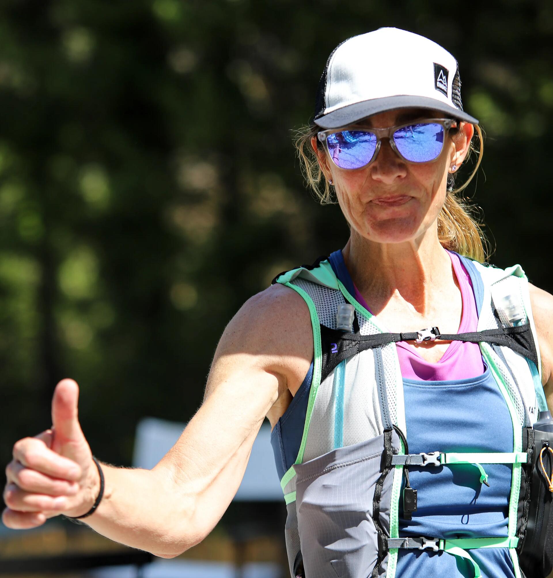 woman in trail running sunglasses and hat 