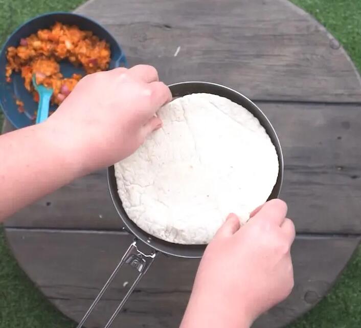 Placing the tortilla on the pan